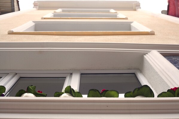 A close-up of a building's facade with multiple windows and decorative moldings.