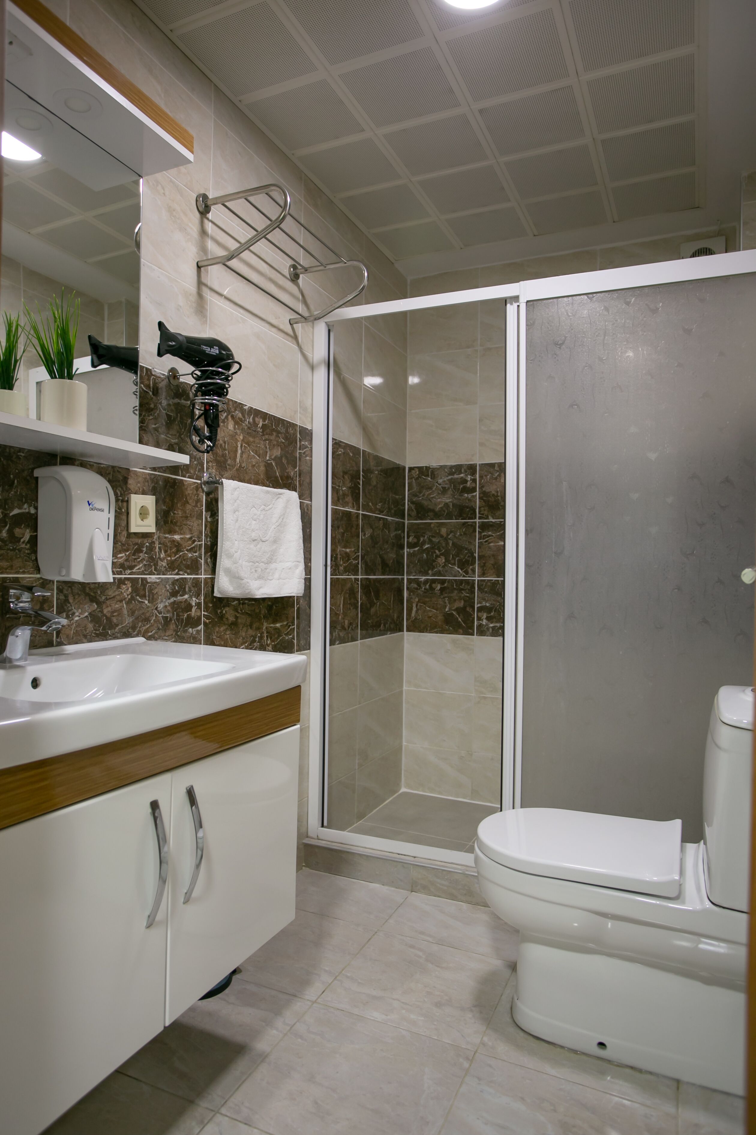 Shower, hair dryer, slippers, towels