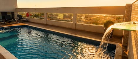 Outdoor pool, pool umbrellas, sun loungers