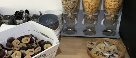 A buffet setup with various food items and utensils.