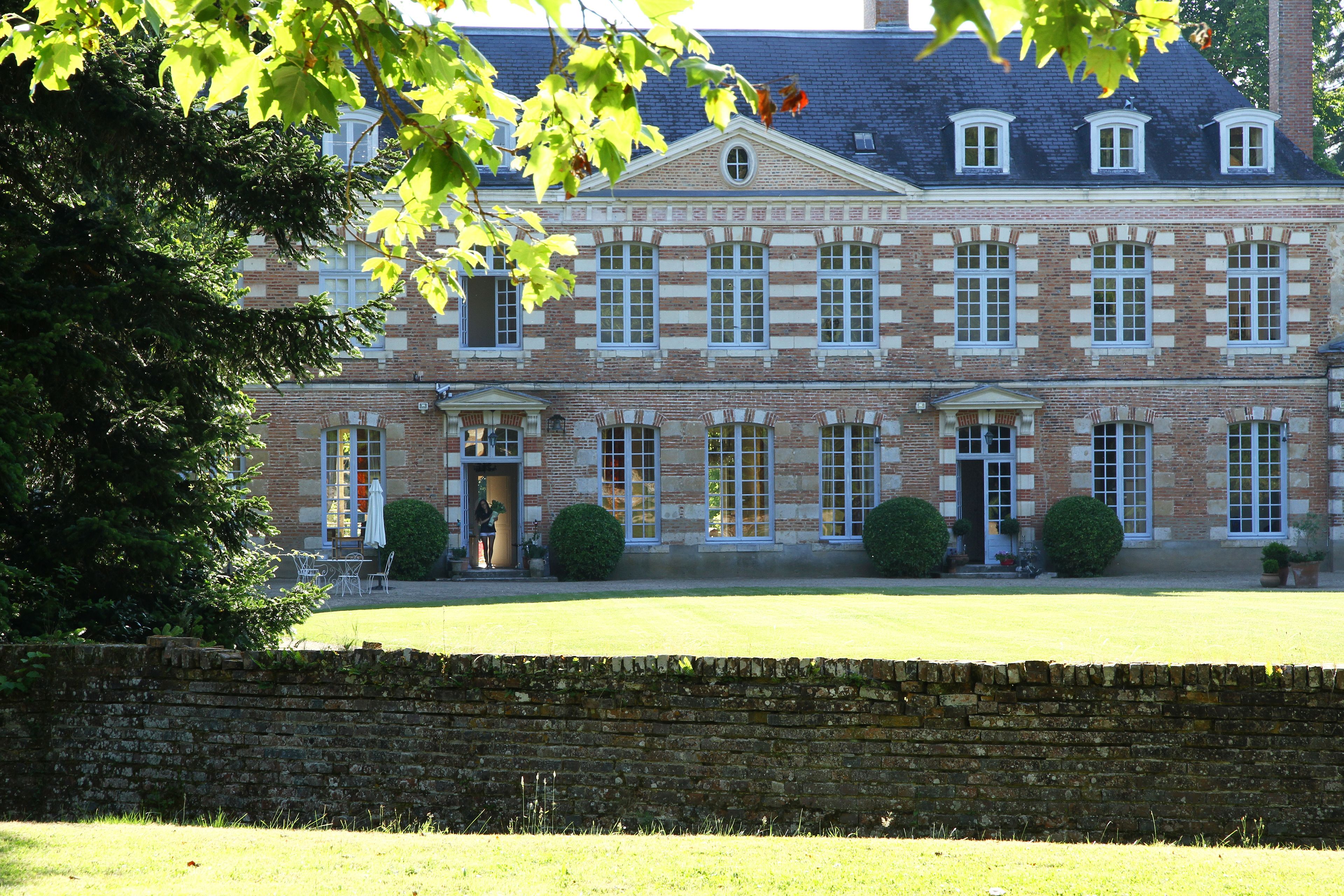 A large, historic building with multiple windows and a symmetrical facade.