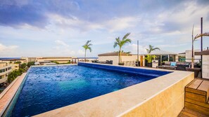 室外游泳池，池畔遮阳伞，日光浴躺椅