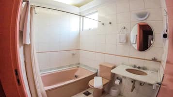 A modern bathroom with a bathtub, toilet, and sink.