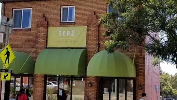 A brick building with a green awning labeled "SEN2 HOTEL & BISTRO Berkeley".