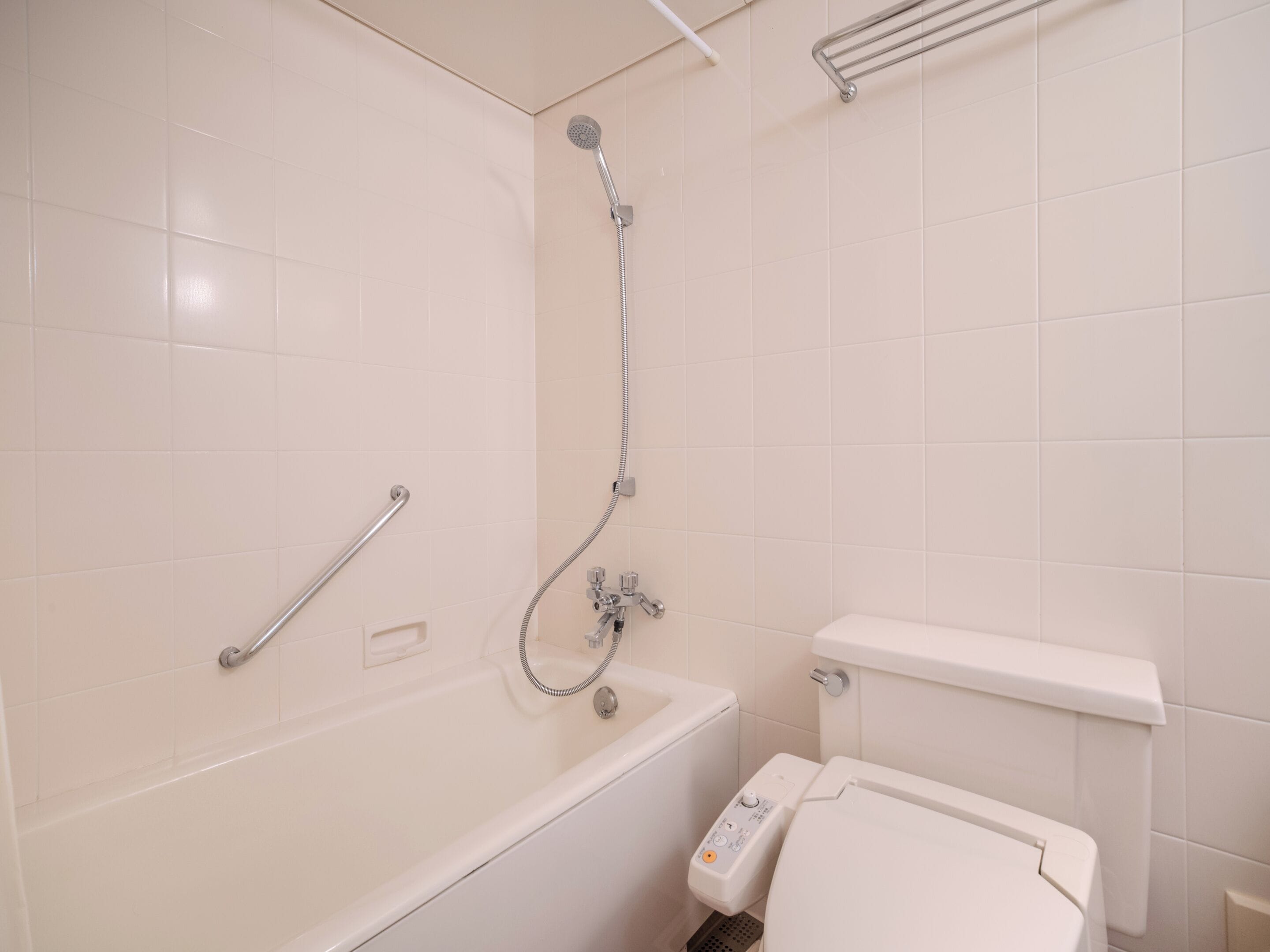 A bathroom with a bathtub, a shower, and a toilet.