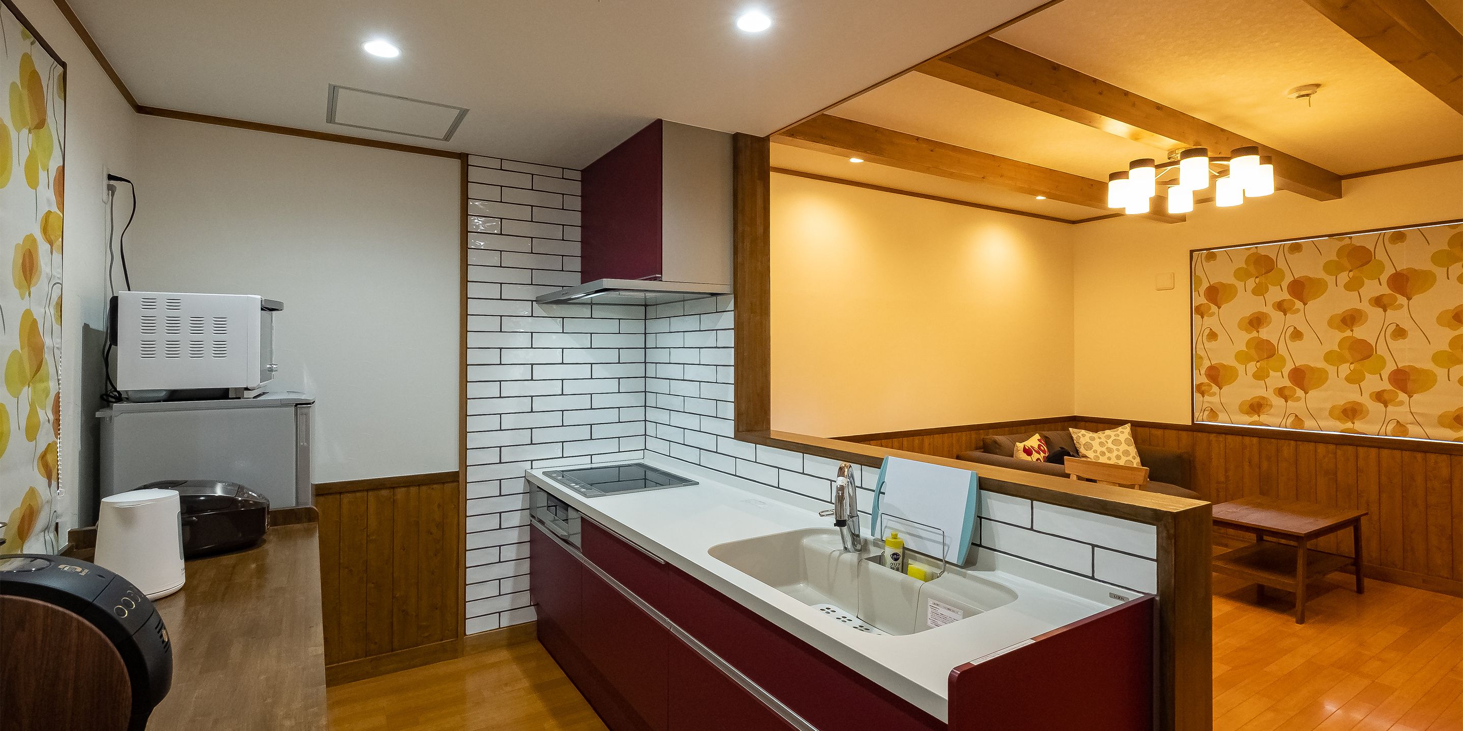 A modern kitchen with a white countertop, a built-in sink, and wooden cabinets.