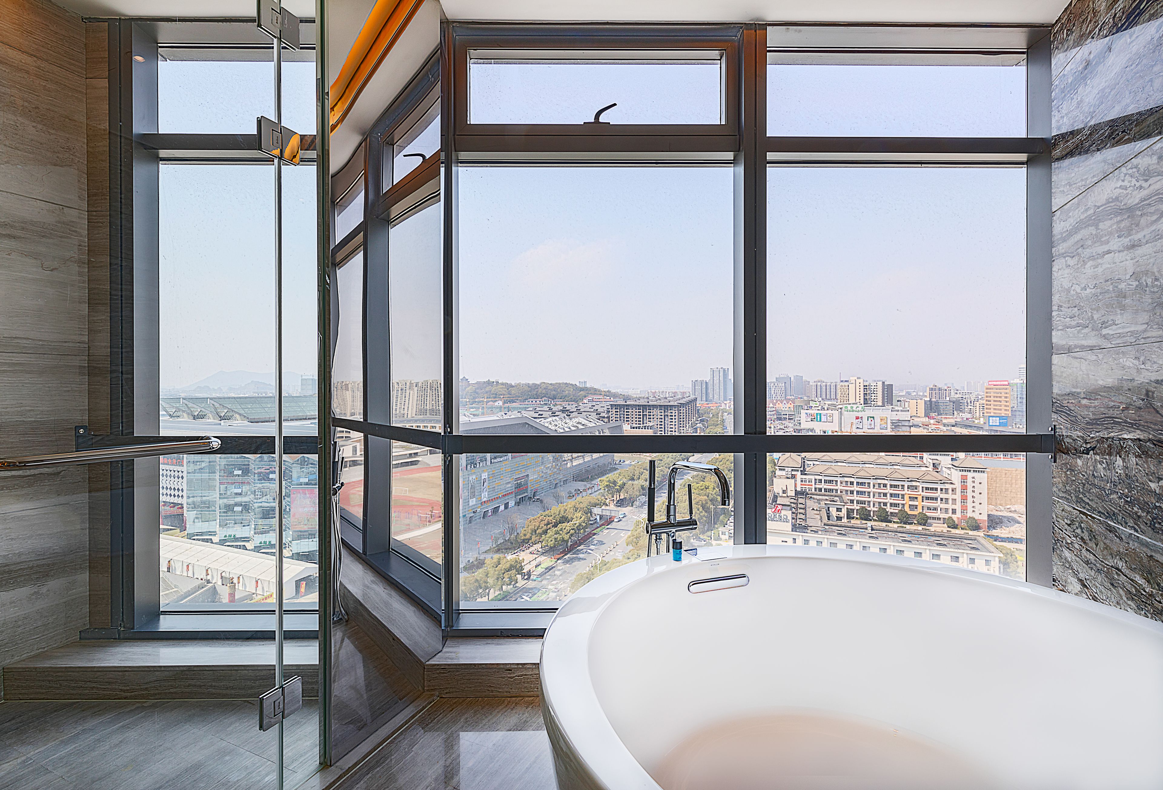 corner deluxe room | bathroom | separate bathtub and shower, designer toiletries, hair dryer, bathrobes