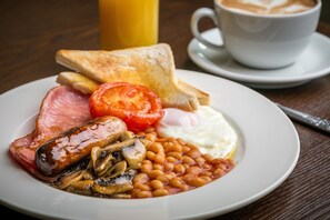 A plate of breakfast food including eggs, beans, tomatoes, and toast. - The Nottinghamshire Hotel and Golf Club (Nottingham)