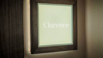 A framed nameplate with the name "Clarence" illuminated.