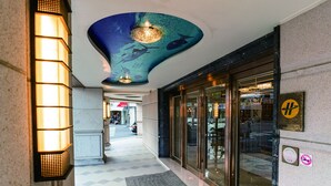 A hotel entrance with a modern design, featuring a unique ceiling with a blue and green color scheme and a central light fixture. - Fish Hotel - Taitung (Taitung)