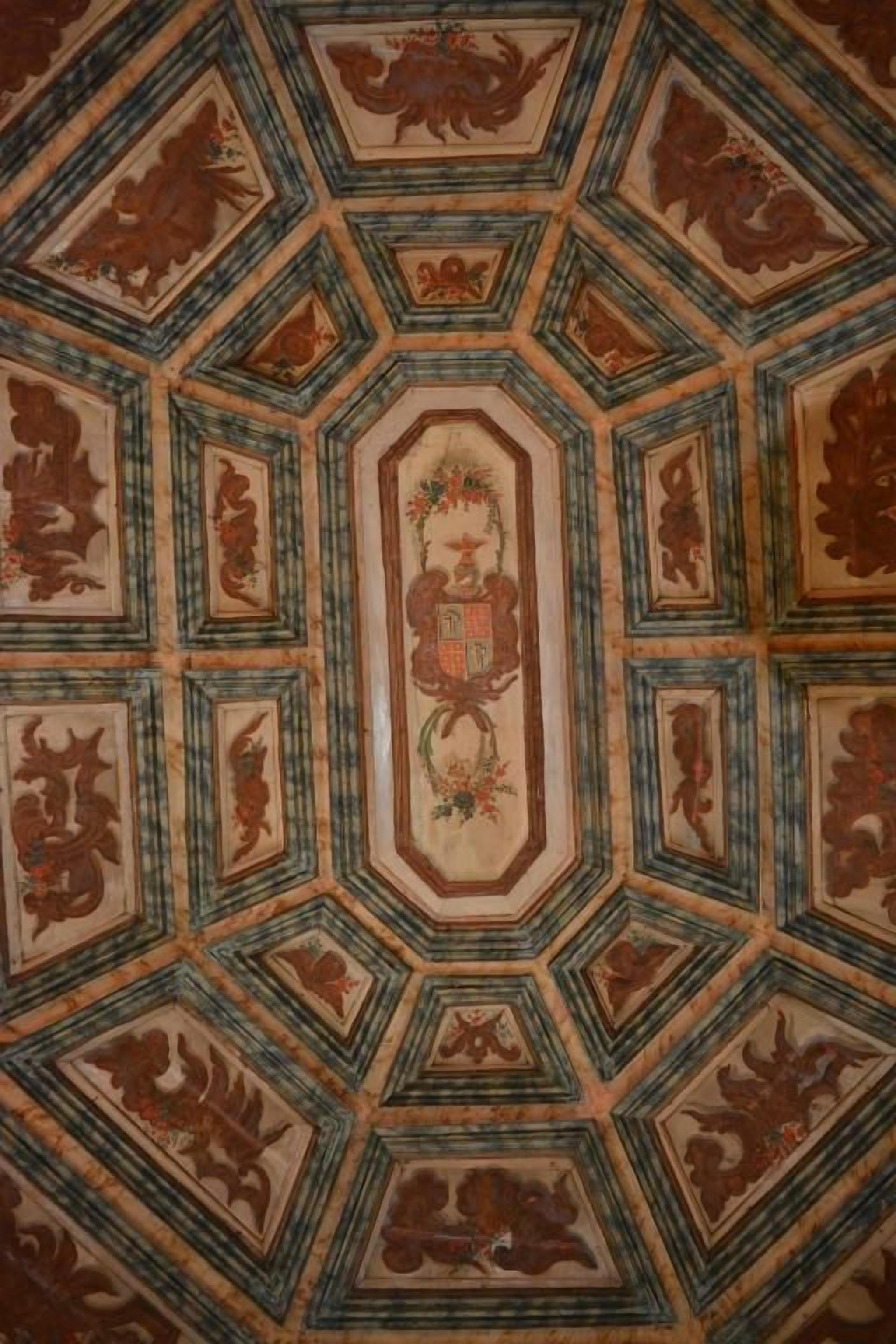 A geometric patterned ceiling with a central medallion.