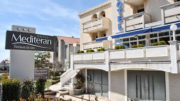 A hotel with a reception area, a staircase, and a sign indicating a reception restaurant.