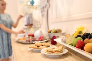 A buffet table with various food items including pastries, fruits, and a slice of pie. - Hotel Miramonti (Fasano)