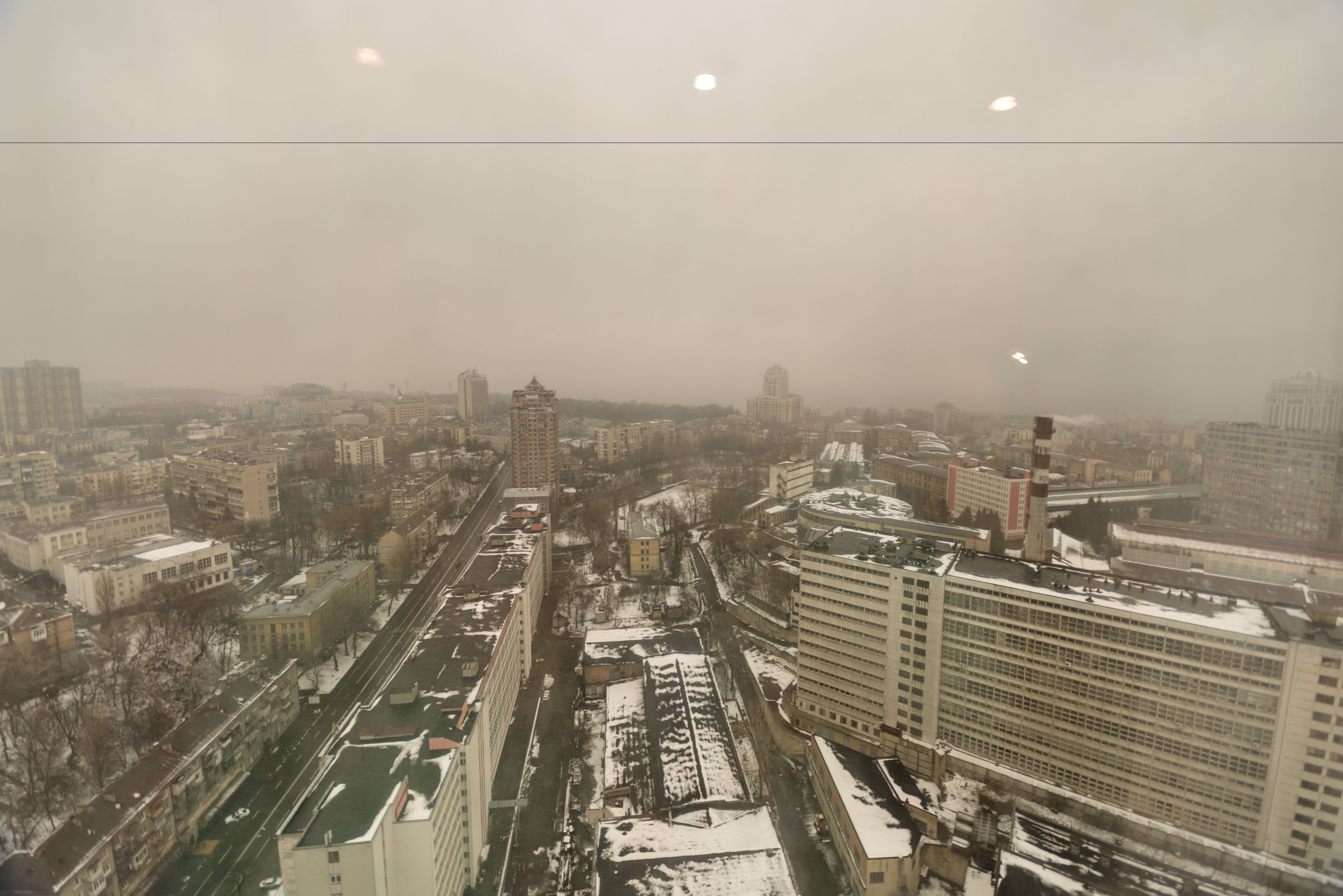 Une vue urbaine avec des bâtiments, des routes et une voie ferrée.