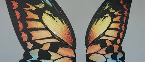 Two butterfly wings with a hashtag.