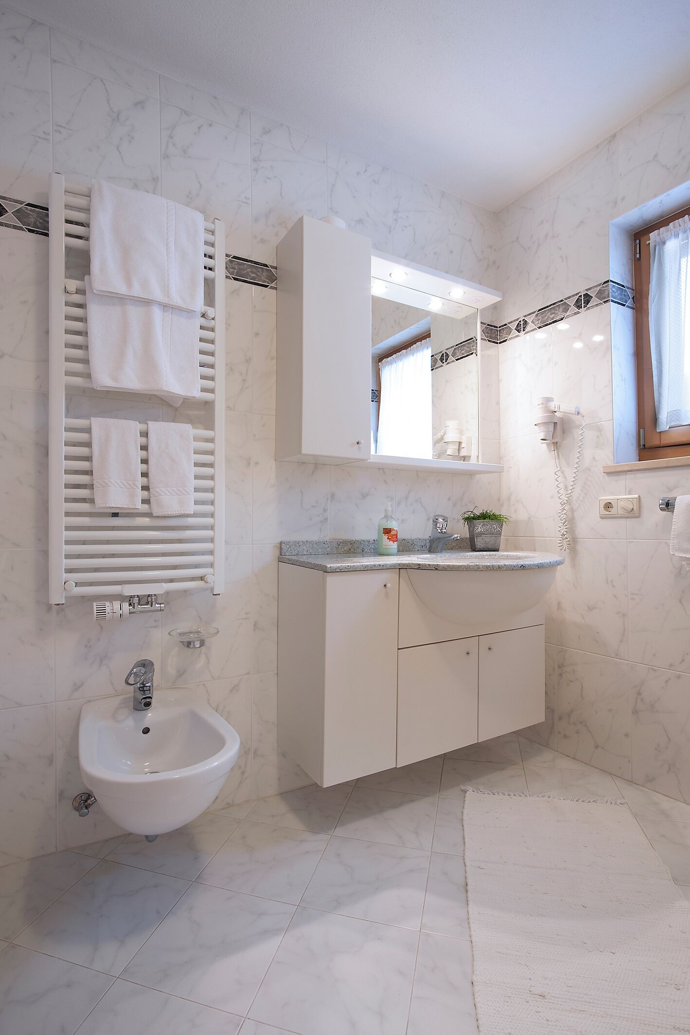 deluxe suite | bathroom | hair dryer, bidet, towels