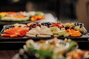 A buffet table with various fruits and vegetables.