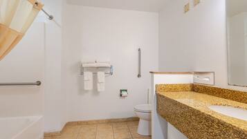 A bathroom with a shower, toilet, and sink.
