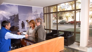 A reception desk with a large window view of the street.