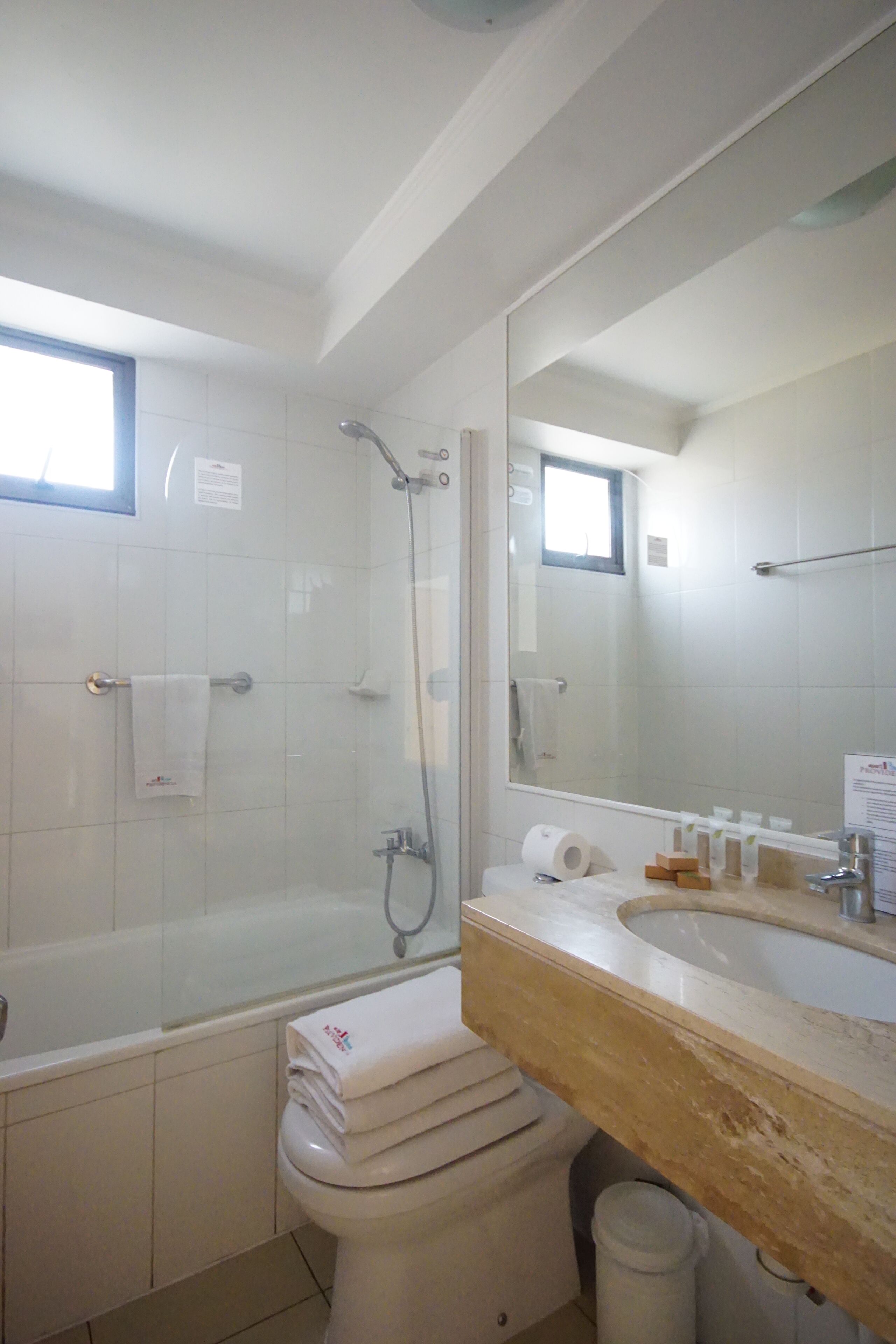 A bathroom with a bathtub, toilet, and sink.