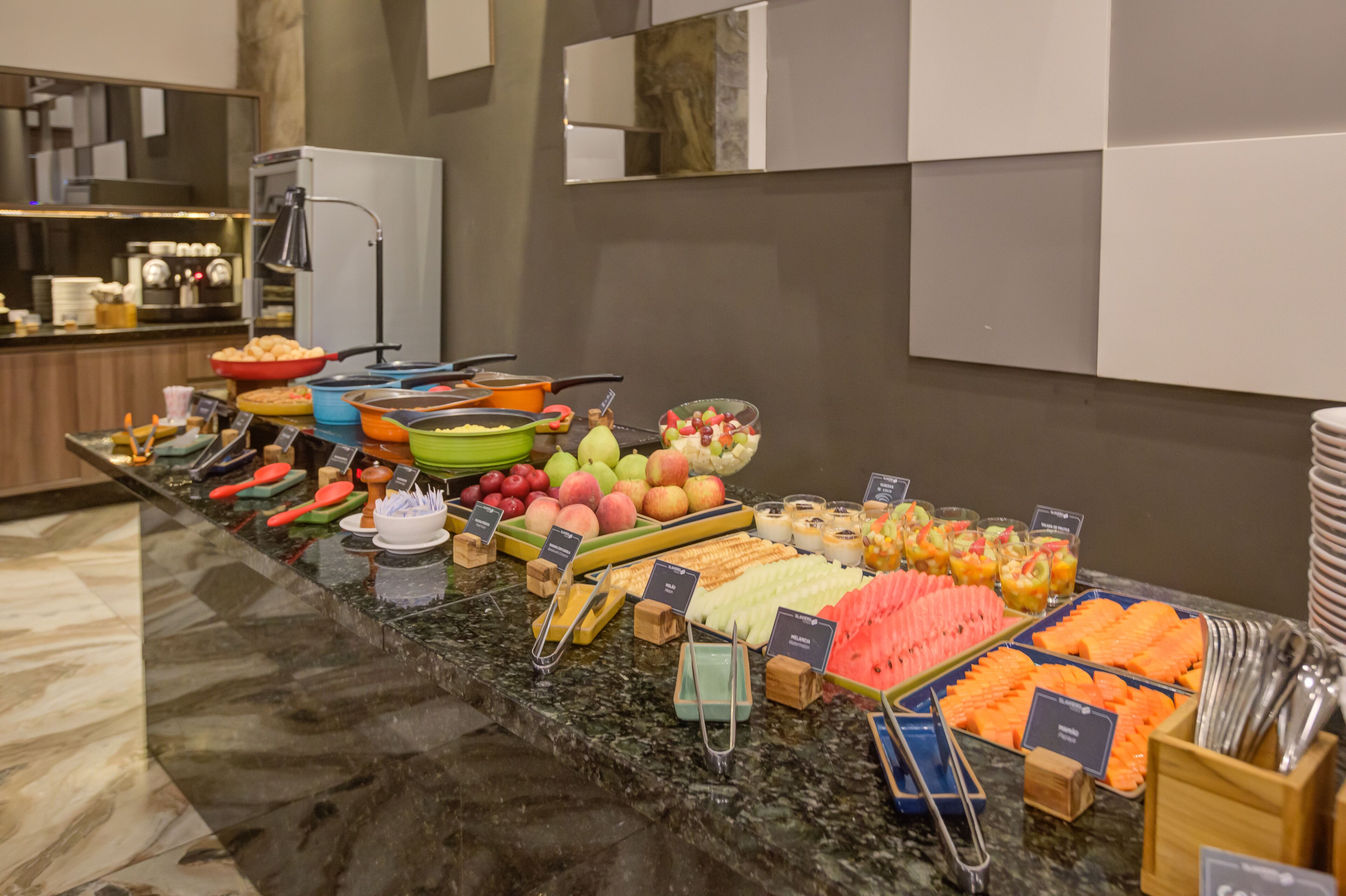 A buffet with various fruits, vegetables, and desserts.