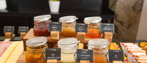 A display of various condiments and spreads on wooden stands with labels.
