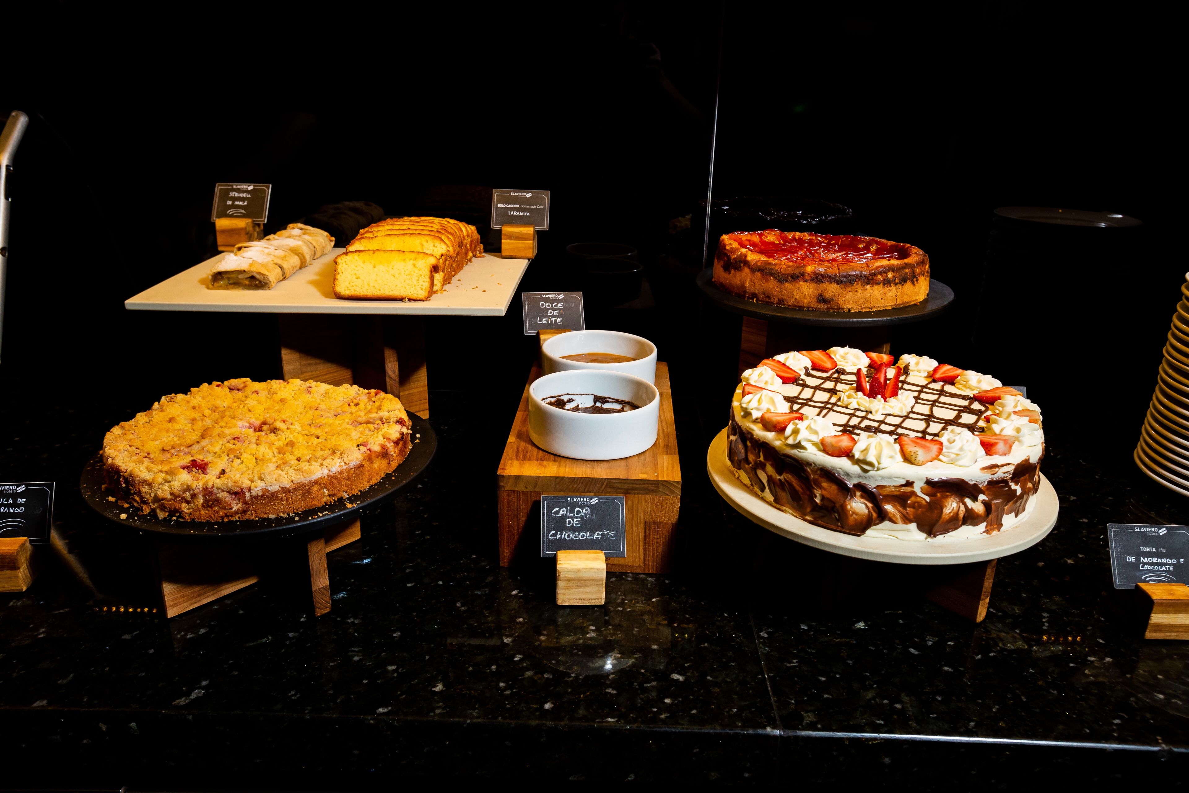 A dessert display with various cakes and pastries.