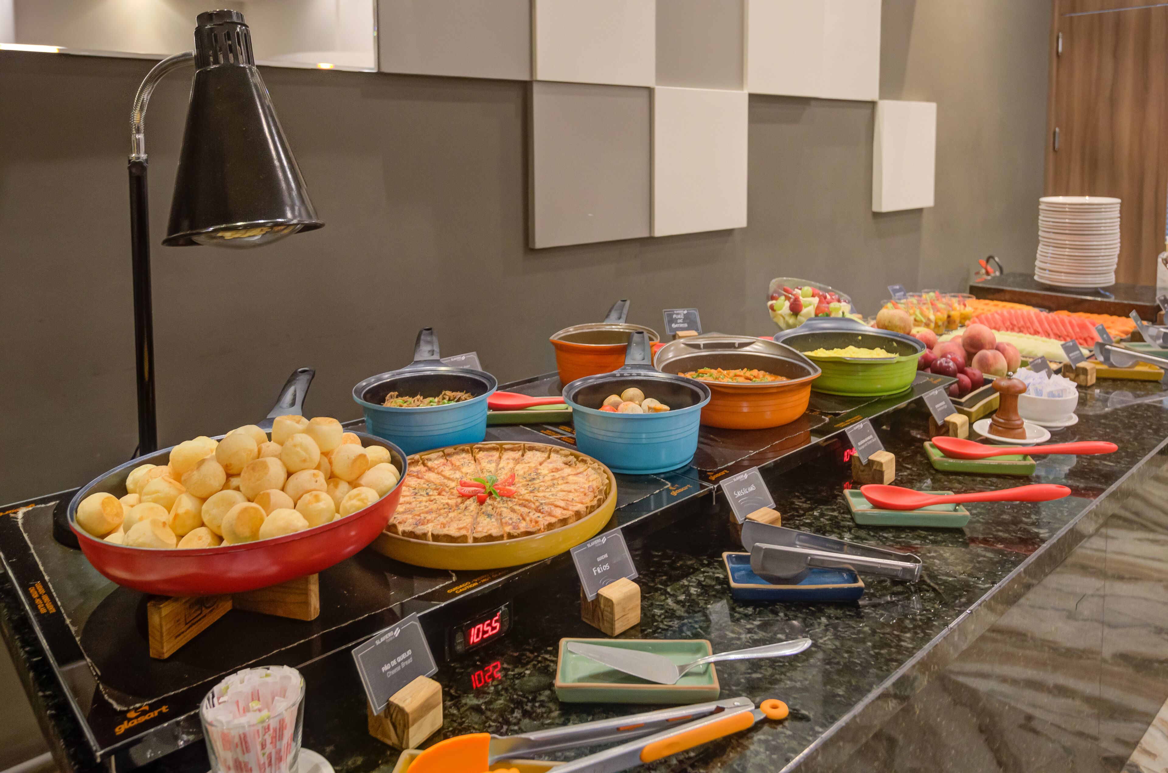 A buffet with various food items and utensils.