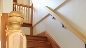 A wooden staircase with a balustrade and a handrail. - 24 East Main Street B&B (Canton)
