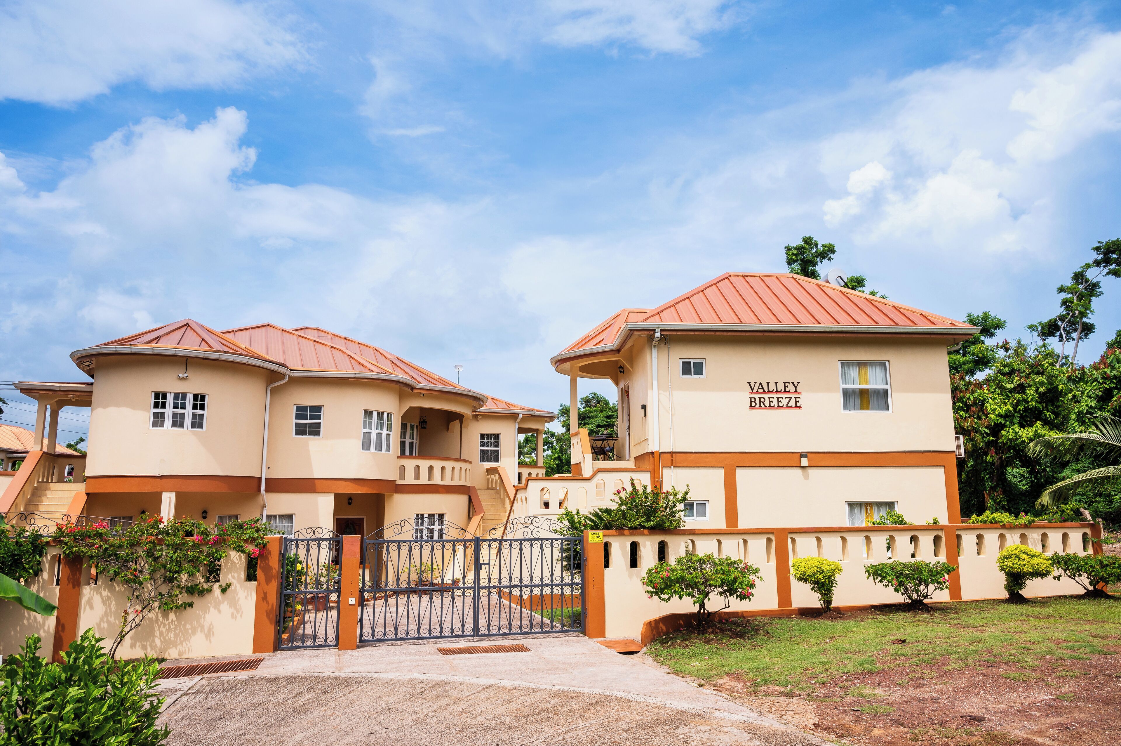 A two-story building with a beige facade and red roofs, labeled "Valley Breeze."