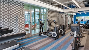 A gym with treadmills, elliptical machines, and weight equipment. - Aloft by Marriott Austin Northwest (Austin)