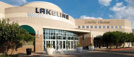 A cinema building with a curved facade, large glass entrance, and a sign reading "Lakeline".