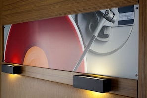 A wall-mounted digital display with a graphic of a hand holding a wrench, set in a wooden frame.