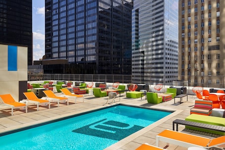 Outdoor pool, open 7:00 AM to 11:00 PM, pool loungers. Aloft by Marriott Houston Downtown