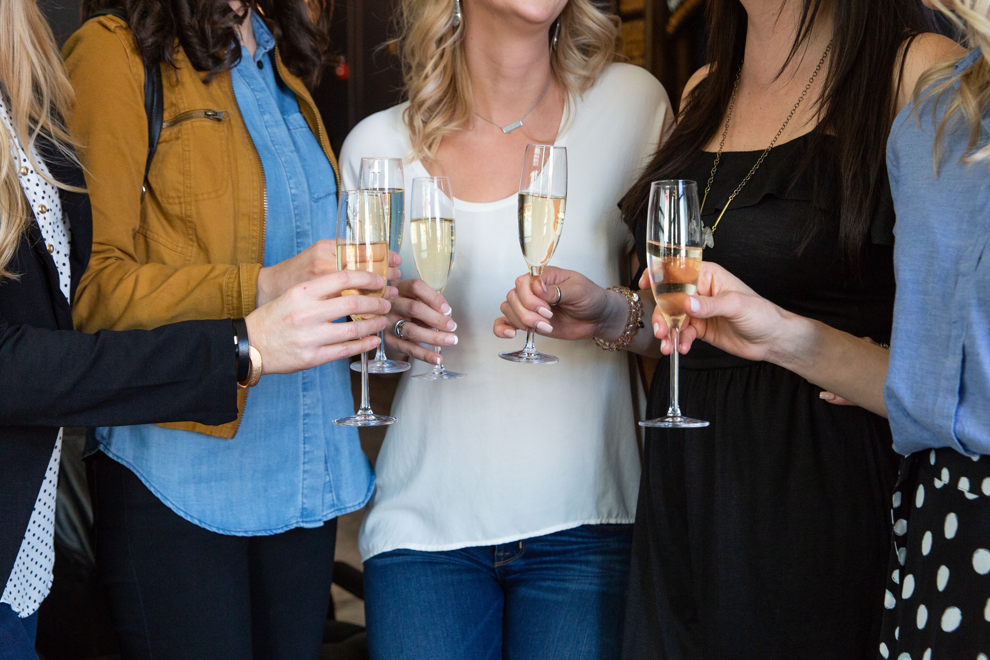 A group of people holding champagne glasses.
