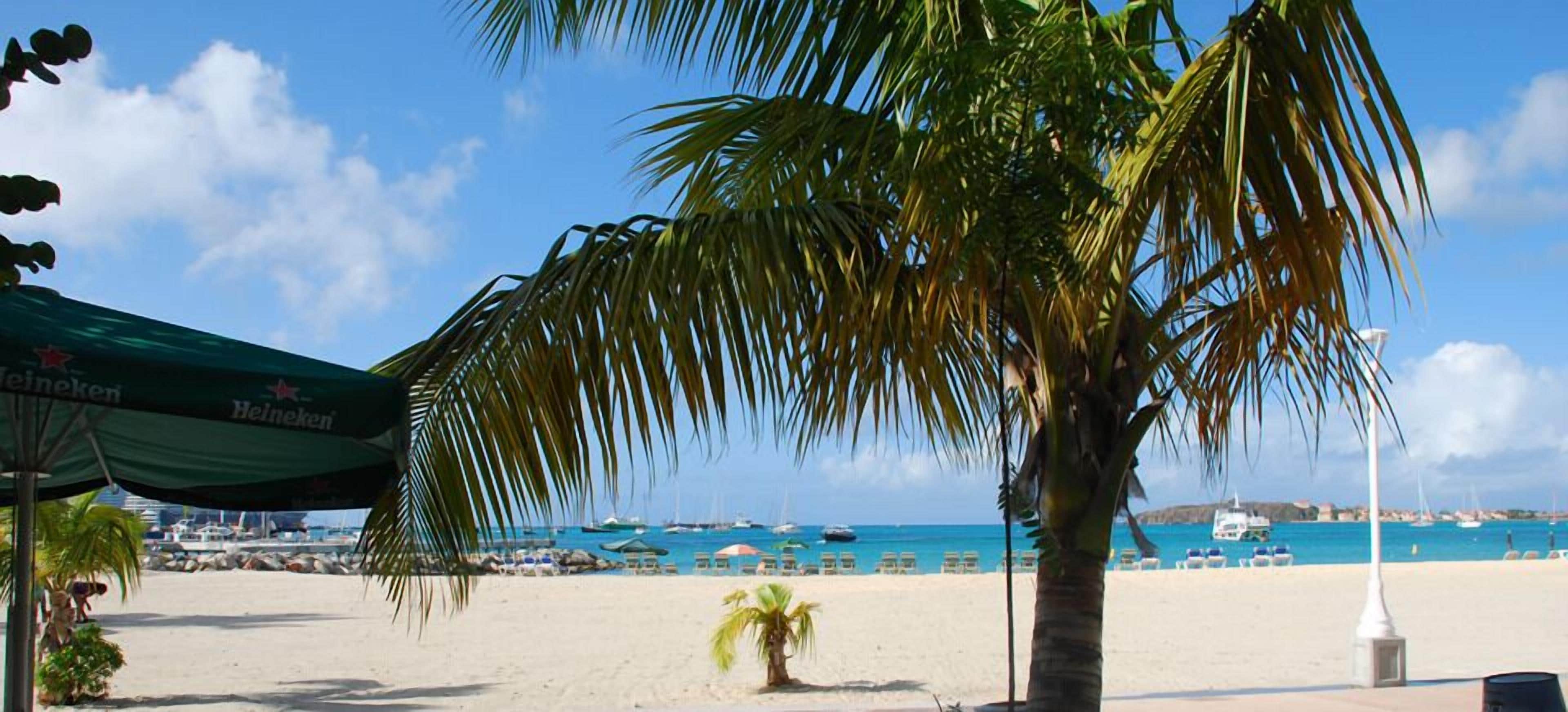 on the beach, sun-loungers, beach umbrellas, beach towels