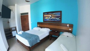 A hotel room with a large bed, a smaller bed, a TV, and a painting on the wall. - Hotel Aryia (Máncora)
