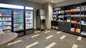 A self-service beverage station with refrigerated drink dispensers and a coffee machine.
