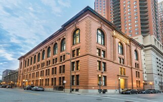 A historic building with a classic architectural style, featuring large windows and a prominent entrance.
