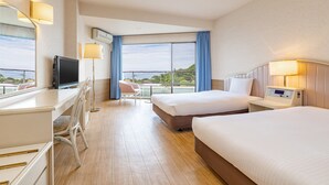 A hotel room with a bed, desk, chair, TV, and a view of the outdoors. - Wan Wan Paradise Izukogen (Ito)