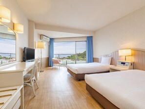 A hotel room with a bed, desk, chair, TV, and a view of the outdoors.