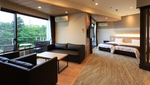 A modern hotel room with a balcony, a sofa, a bed, and a desk. - Wan Wan Paradise Izukogen (Ito)
