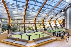 An indoor space with a high ceiling, glass panels, and seating areas. - Wan Wan Paradise Izukogen (Ito)