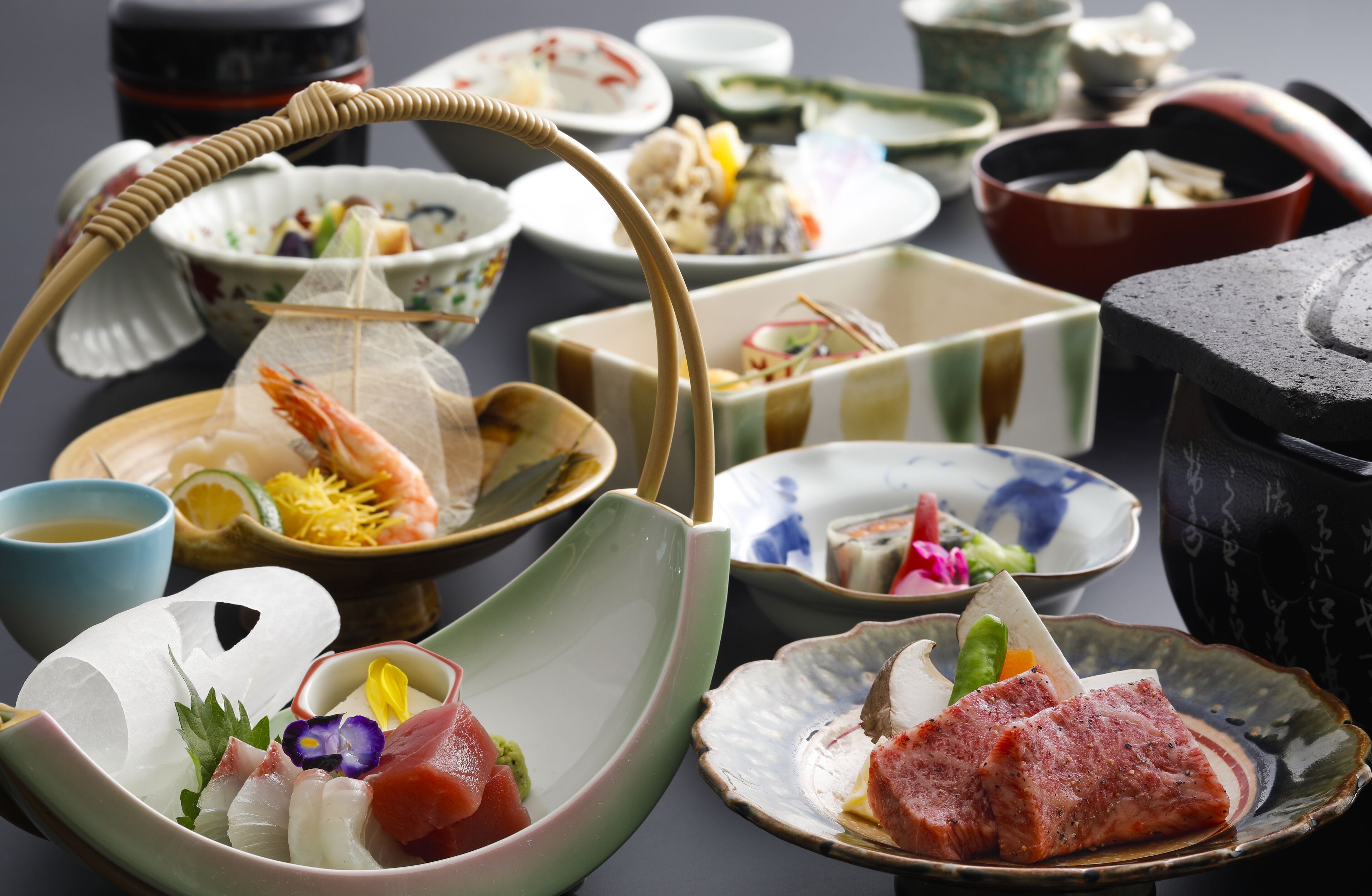 A variety of traditional Japanese dishes and utensils on a table.