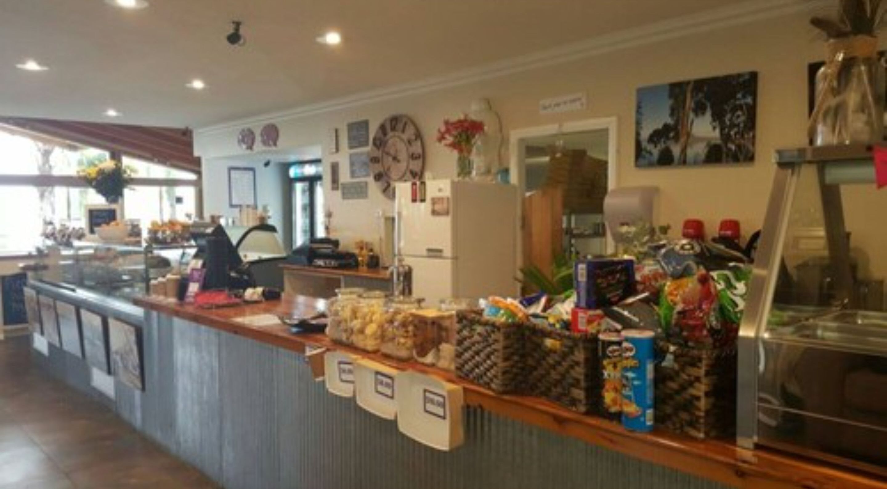 A buffet counter with various food items and condiments.