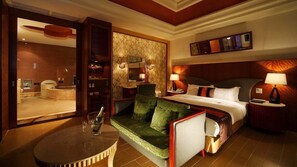 A hotel room with a bed, a seating area with a table, a minibar, a bathroom, and a large mirror. - Seasons Boutique Motel (Kaohsiung)