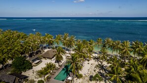 A resort with a pool, palm trees, and ocean views. - SEED Resort (Rote Island)