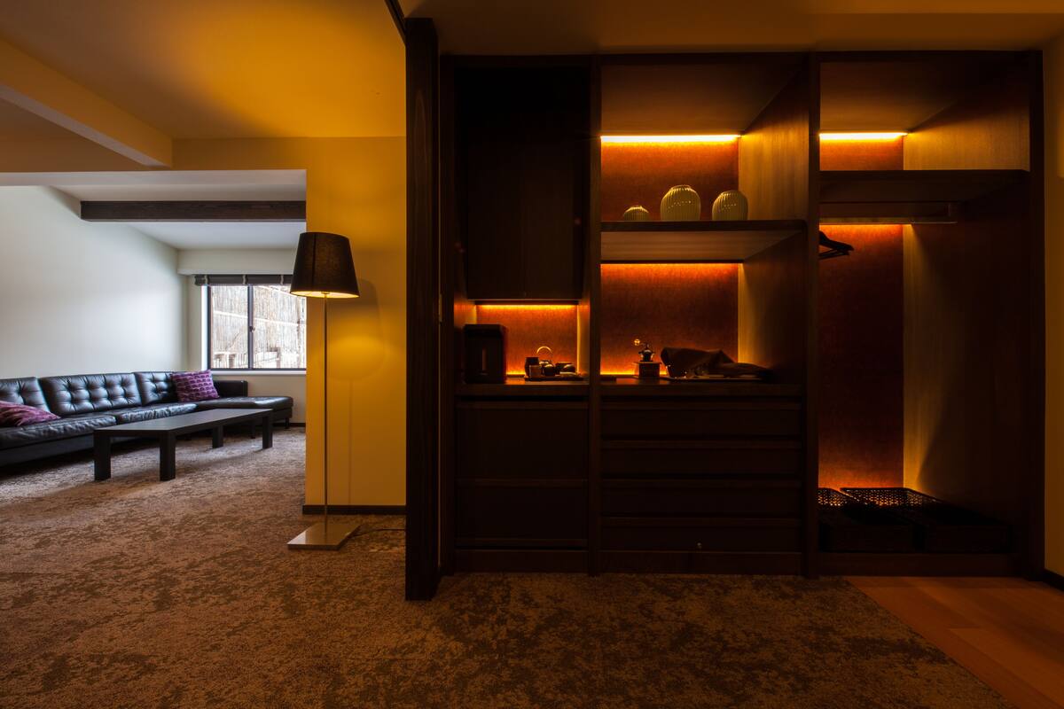 A modern living room with a sofa, a coffee table, and a lamp.
