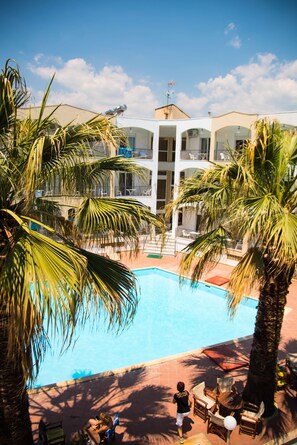 Seasonal outdoor pool, open 10:00 AM to 6:00 PM, pool umbrellas