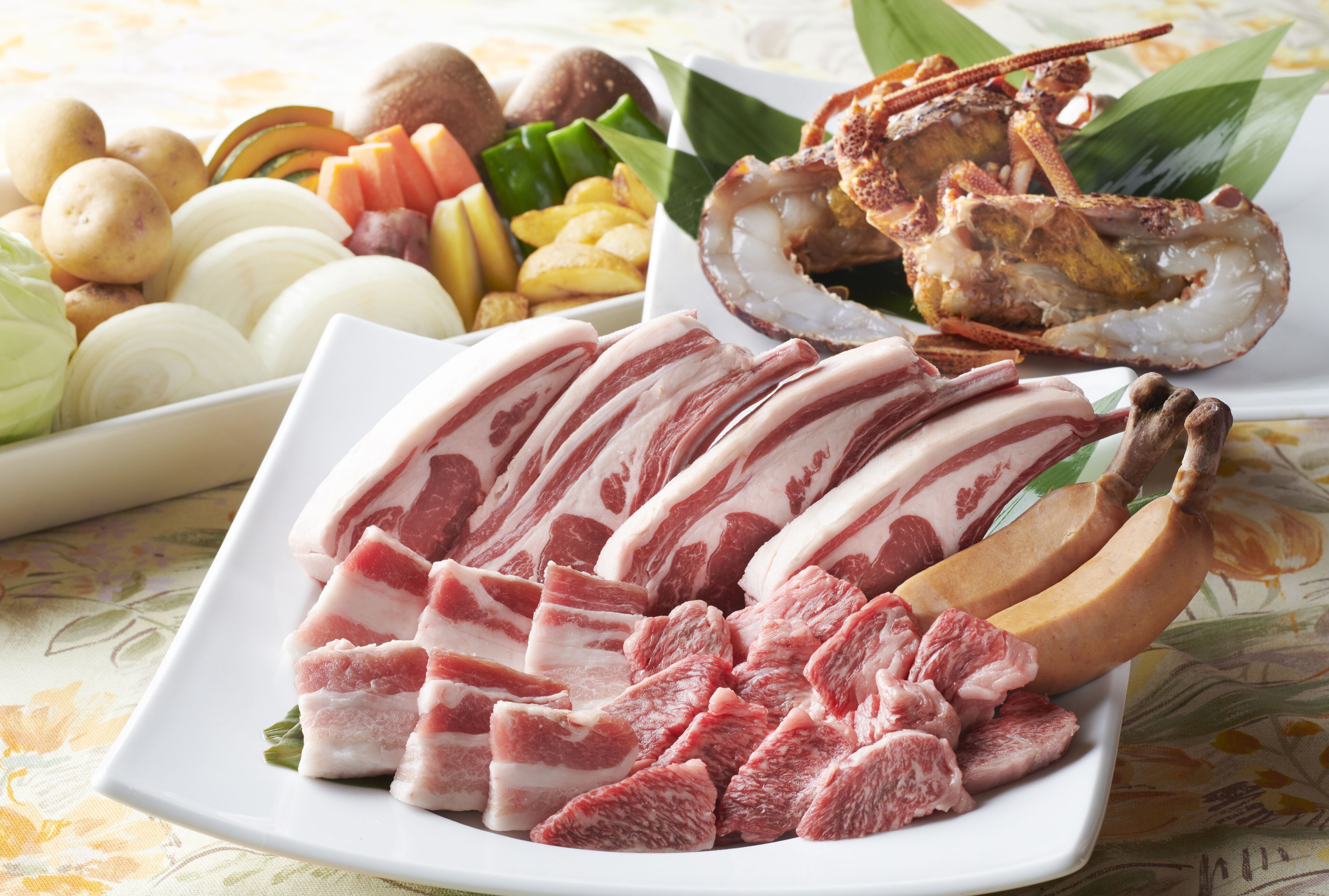 A plate of sliced meat, bananas, and various vegetables.